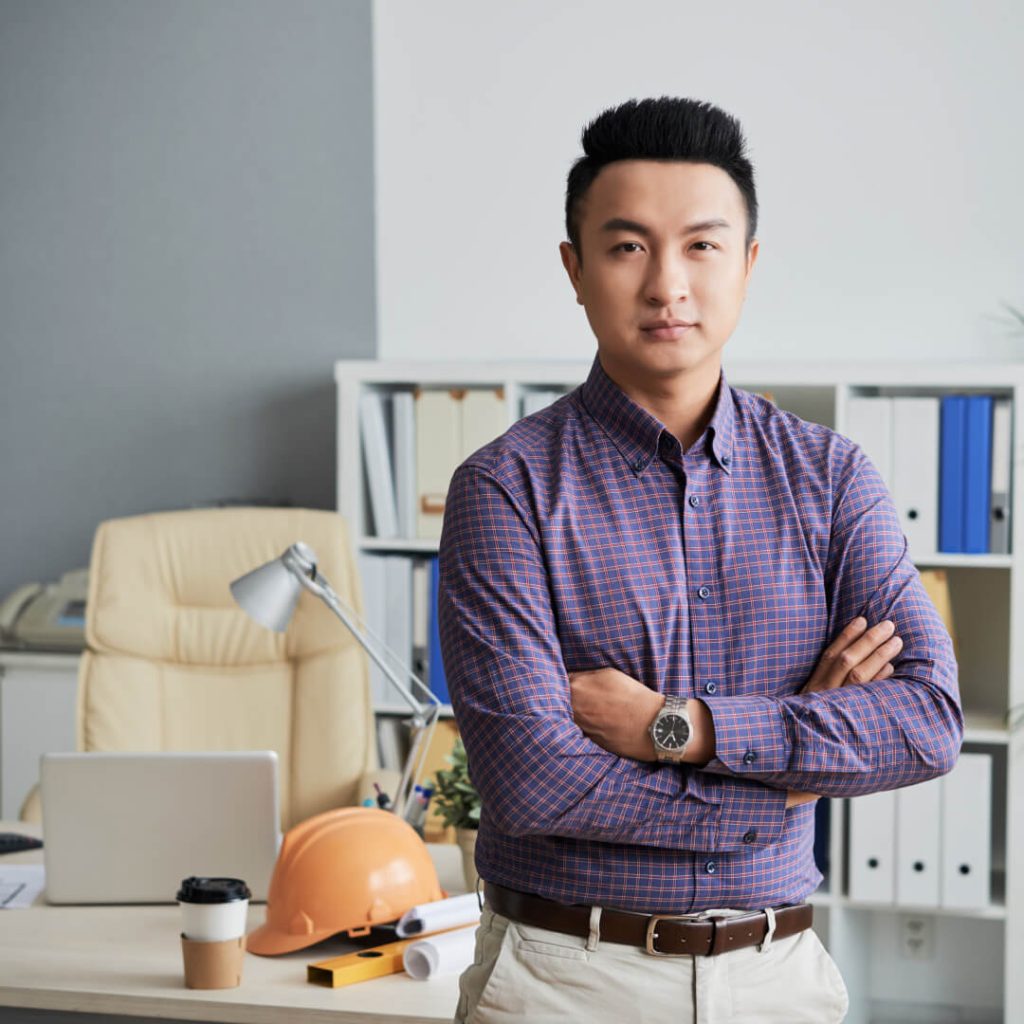 asian man with dark hair smiling at the camera